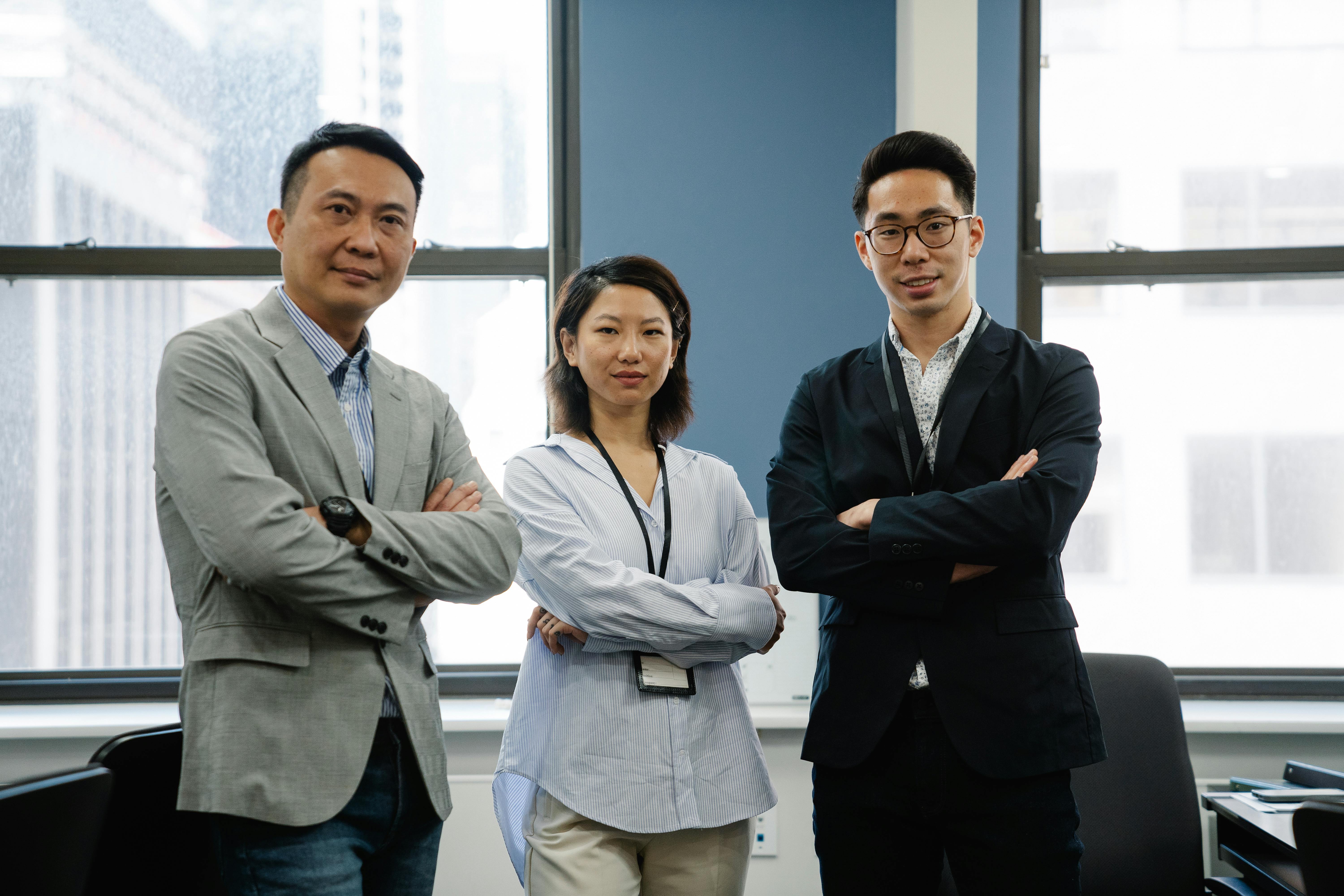 Photo of a Group of Employees with Their Arms Crossed · Free Stock Photo