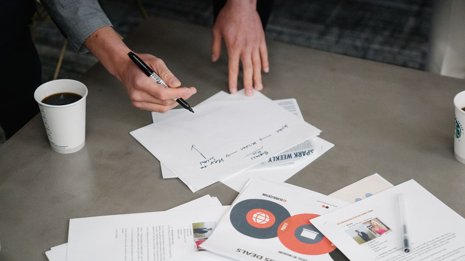 Social media manager scheduling content on a phone and laptop