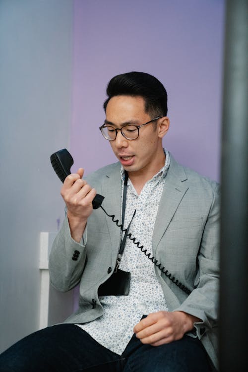 Free Man in Gray Suit Holding a Telephone Stock Photo