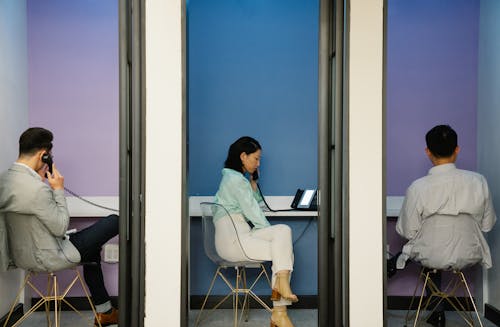 Business People Sitting in Office Booths 