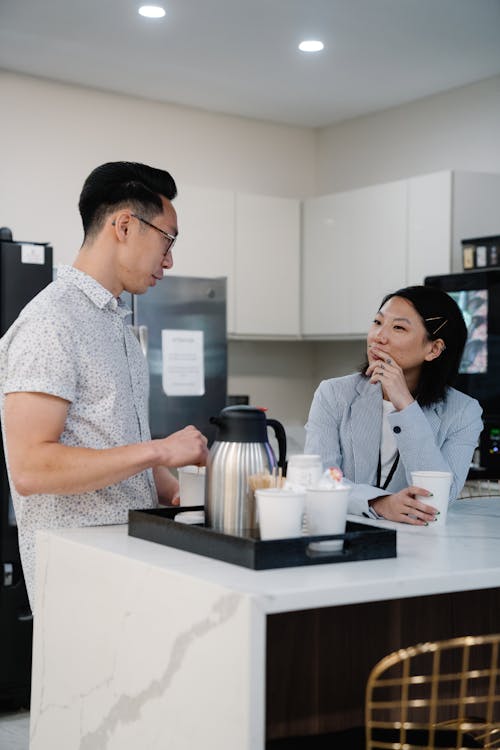 Man Making Coffee with a Woman