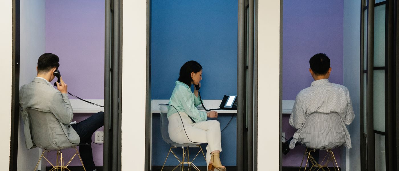 Professionals collaborating using Microsoft Teams Phone in a modern small business office environment, highlighting digital communication.