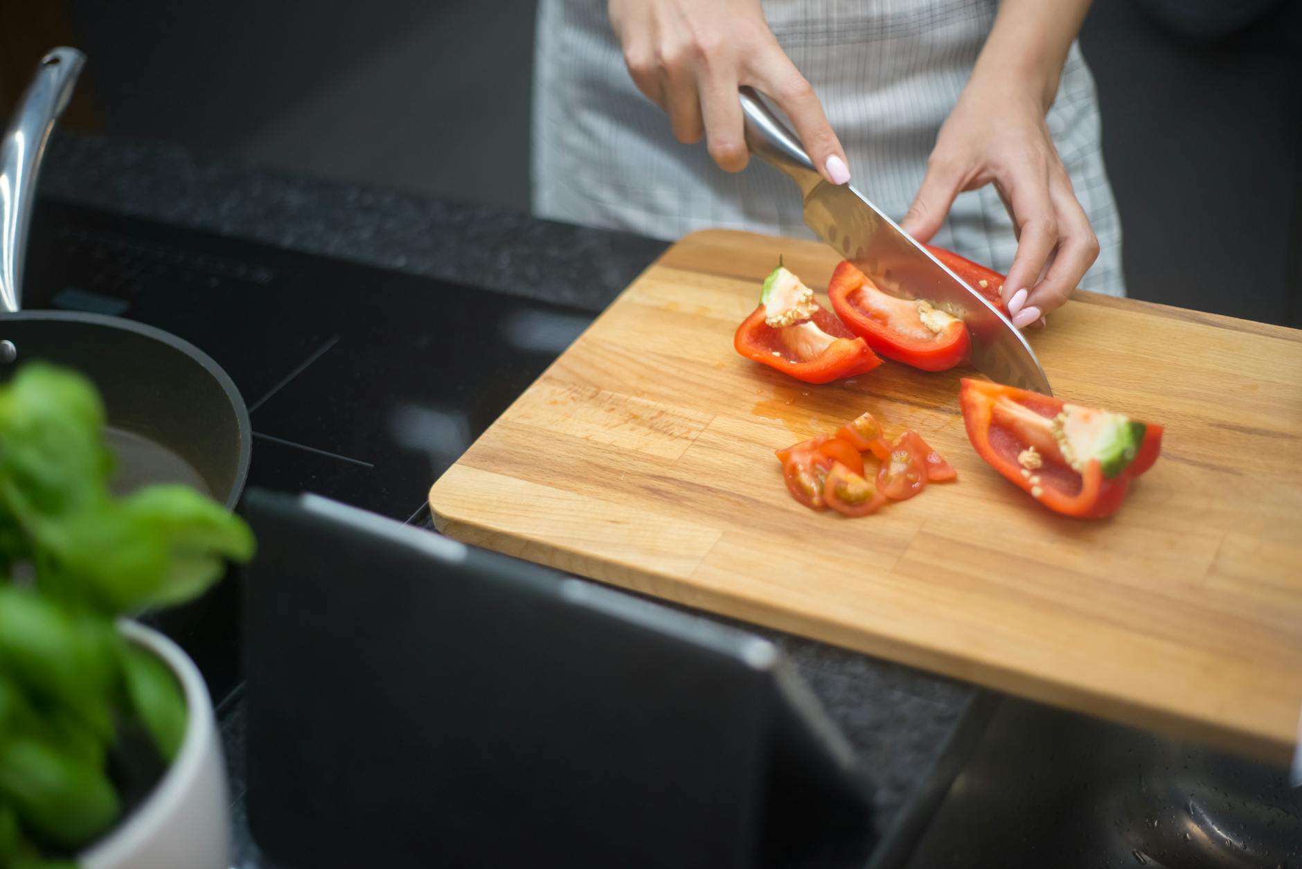 https://www.pexels.com/photo/a-person-slicing-red-bell-pepper-7964650/