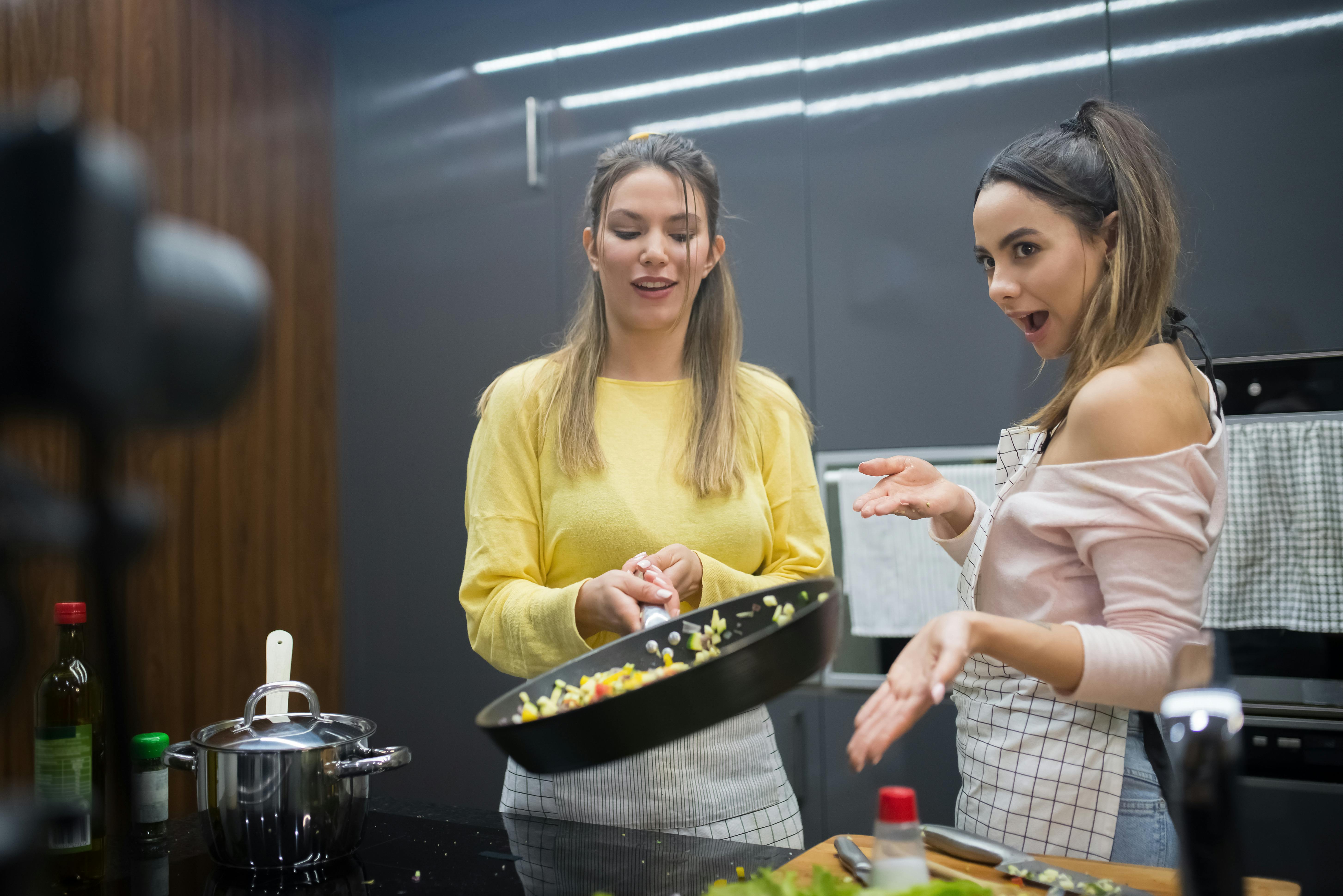 a women cooking while video blogging