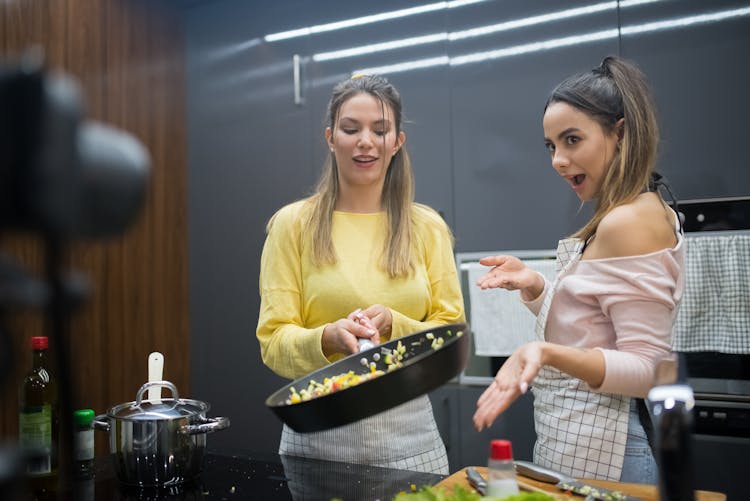 A Women Cooking While Video Blogging 