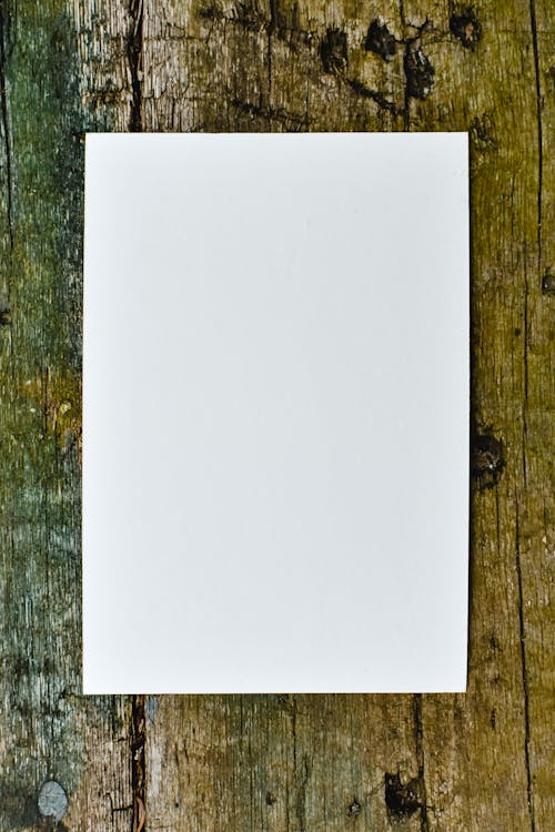 White Printer Paper on Wooden Table