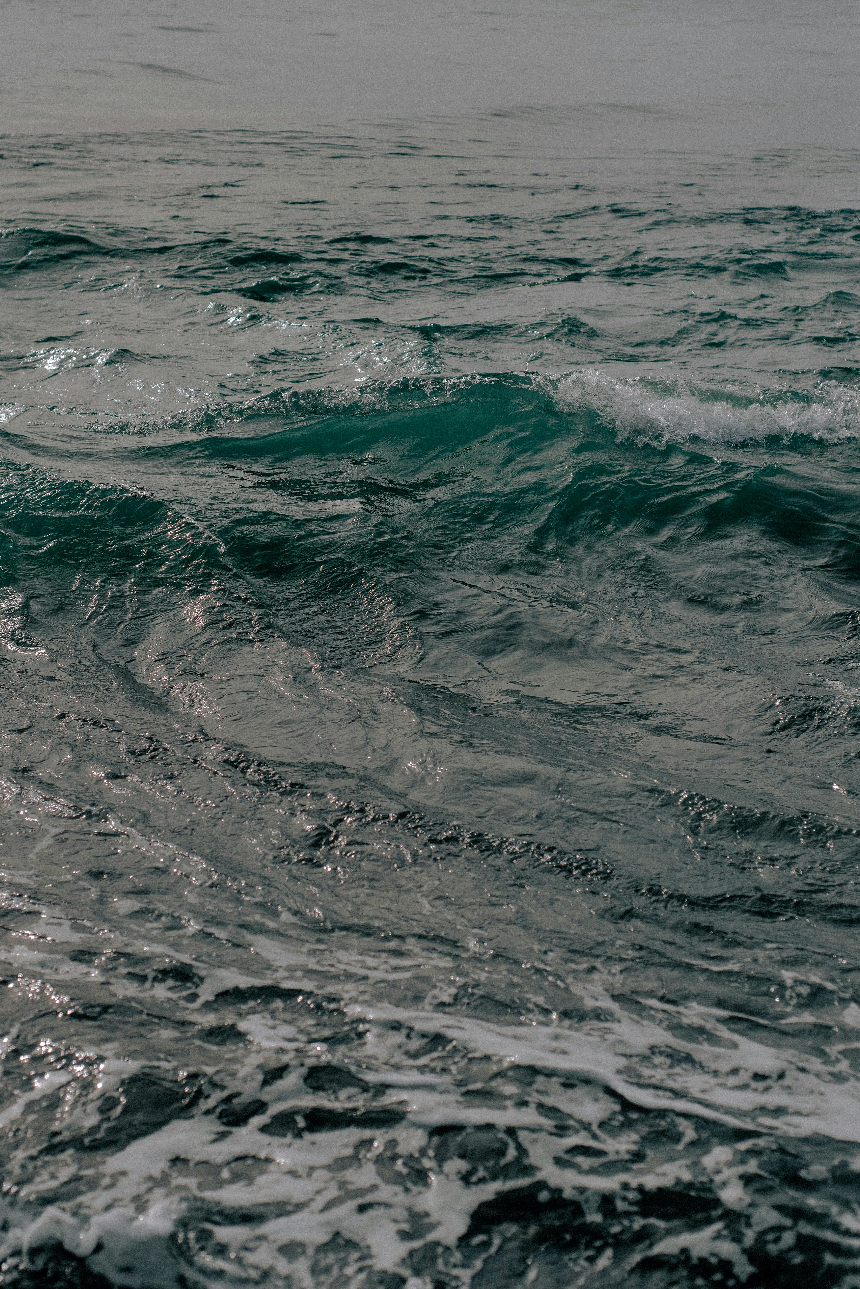 Captivating view of ocean waves rolling under a cloudy sky, creating a dramatic seascape.