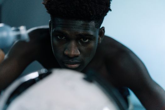 Close-up of a pensive, serious athlete focused on training indoors.