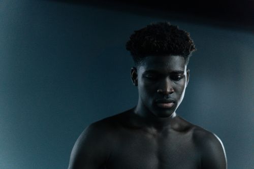 Free Moody studio portrait of a shirtless black man, deep in contemplation. Stock Photo
