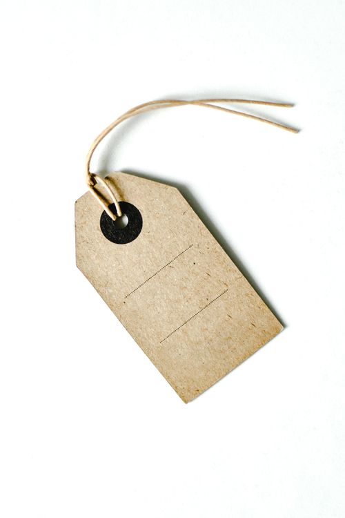 Free Simple brown paper tag with string on a white background, ideal for design. Stock Photo