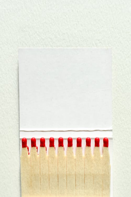 Close-Up Shot of Matchsticks on White Paper