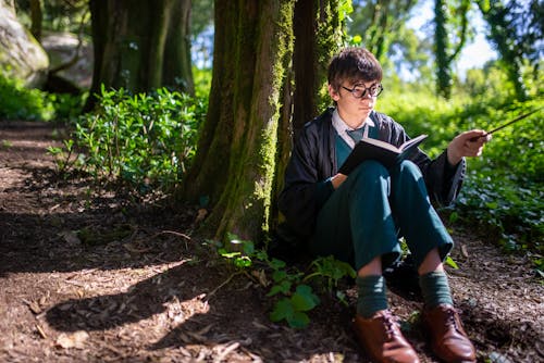Free A Boy Sitting on the Ground Stock Photo
