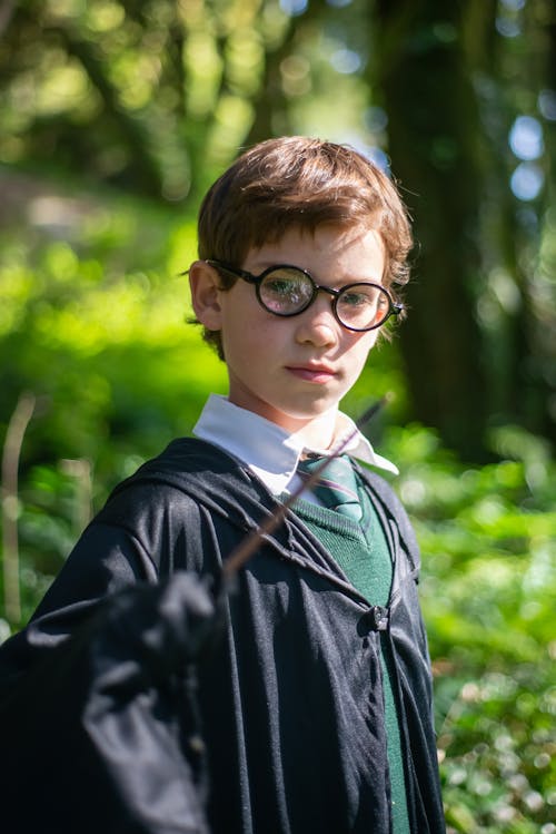 Boy in Black Framed Eyeglasses Holding a Wand