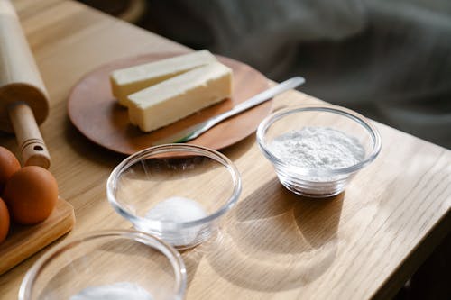 Close-Up Shot of Baking Ingredients on Wooden Table