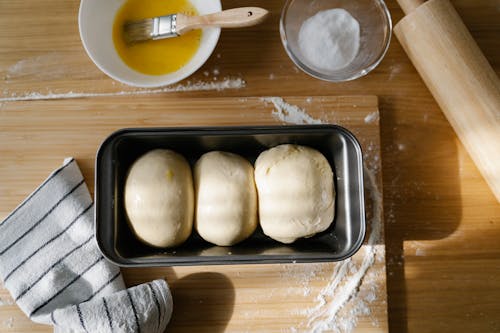 Raw Dough for Buns in a Baking Tray 