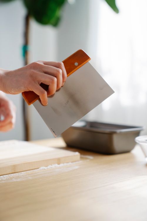 Close Up Shot of a Person Holding a Scraper · Free Stock Photo