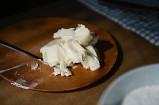 Close-Up Shot of a Creamy Butter on a Wooden Plate