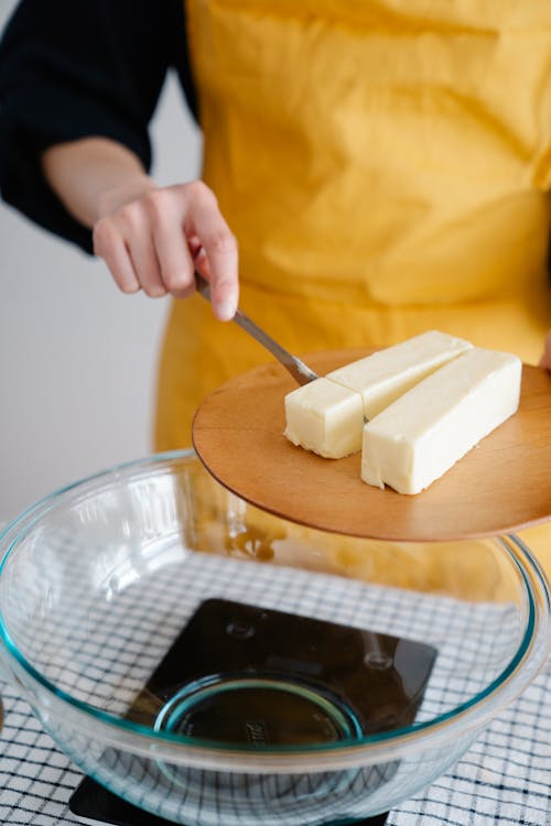 Close-Up Shot of a Person Slicing a Butter