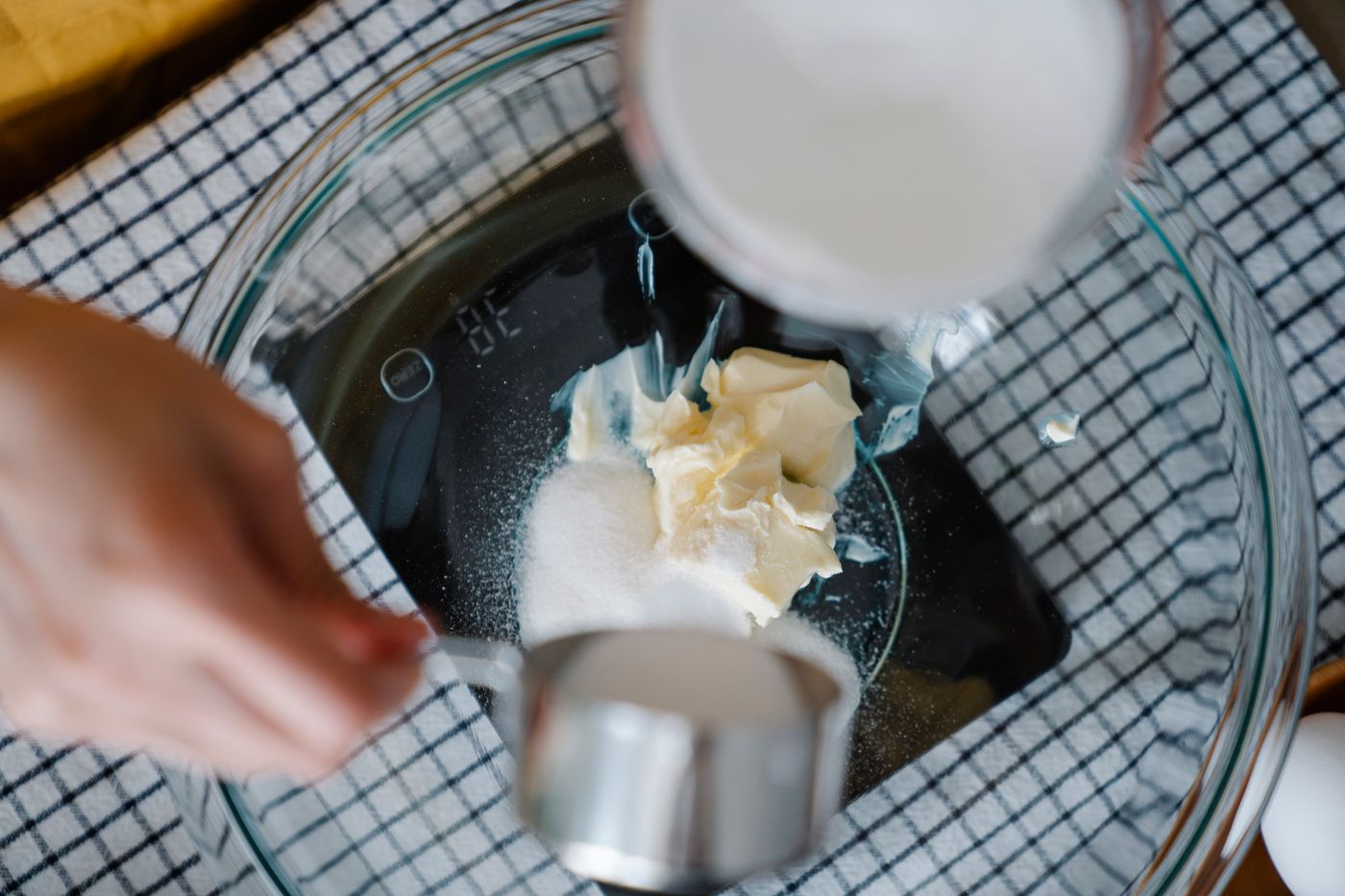 Baking ingredients being weighed on a digital kitchen scale