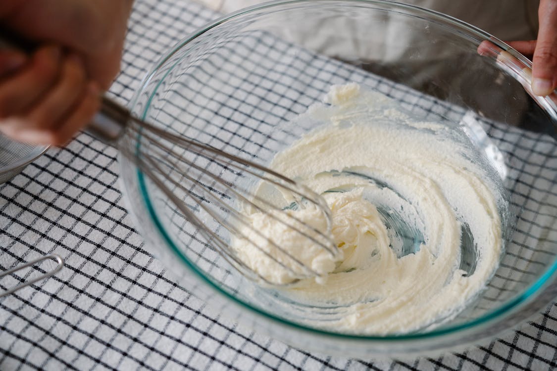 Close Up of Hand Mixing in Bowl