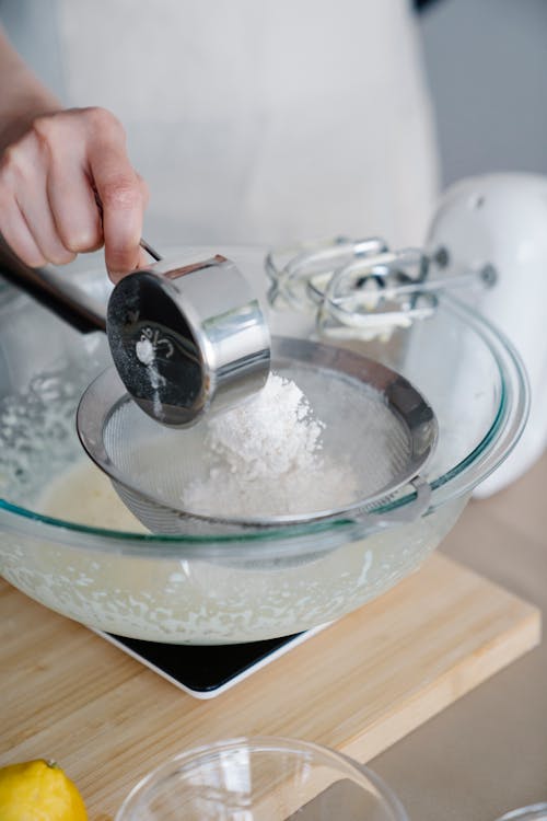 A Baker Straining Flour 