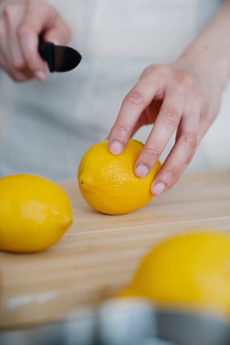 Person Cutting Lemons