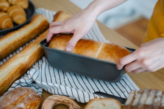 Person Holding Tray of Bread