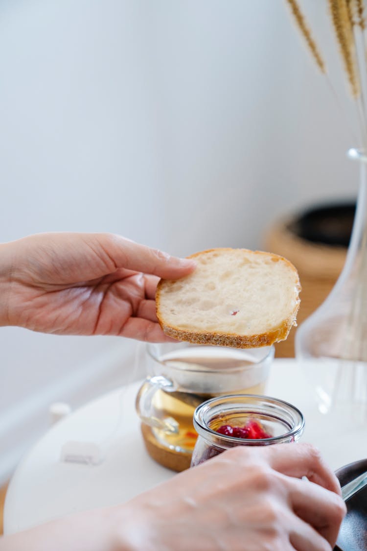 Woman Holding A Slice Of Bread 