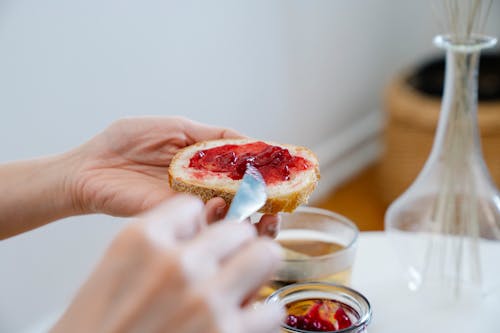 Free Spreading Strawberry Jam on Bread Stock Photo