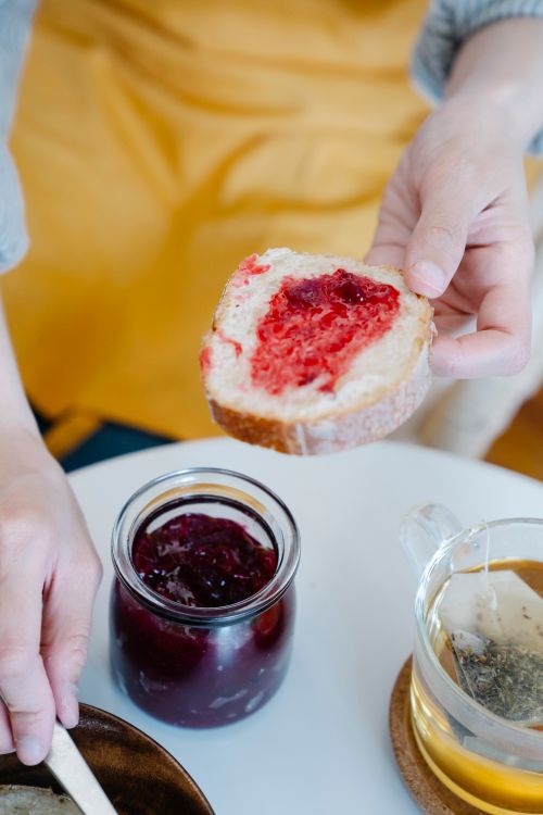 Free A close-up view of homemade bread with a spread of fresh jam, perfect for breakfast. Stock Photo