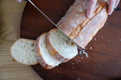 Woman Cutting Baguette 