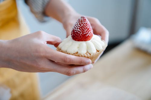 Close-Up Shot of a Person Holding a Cupcake