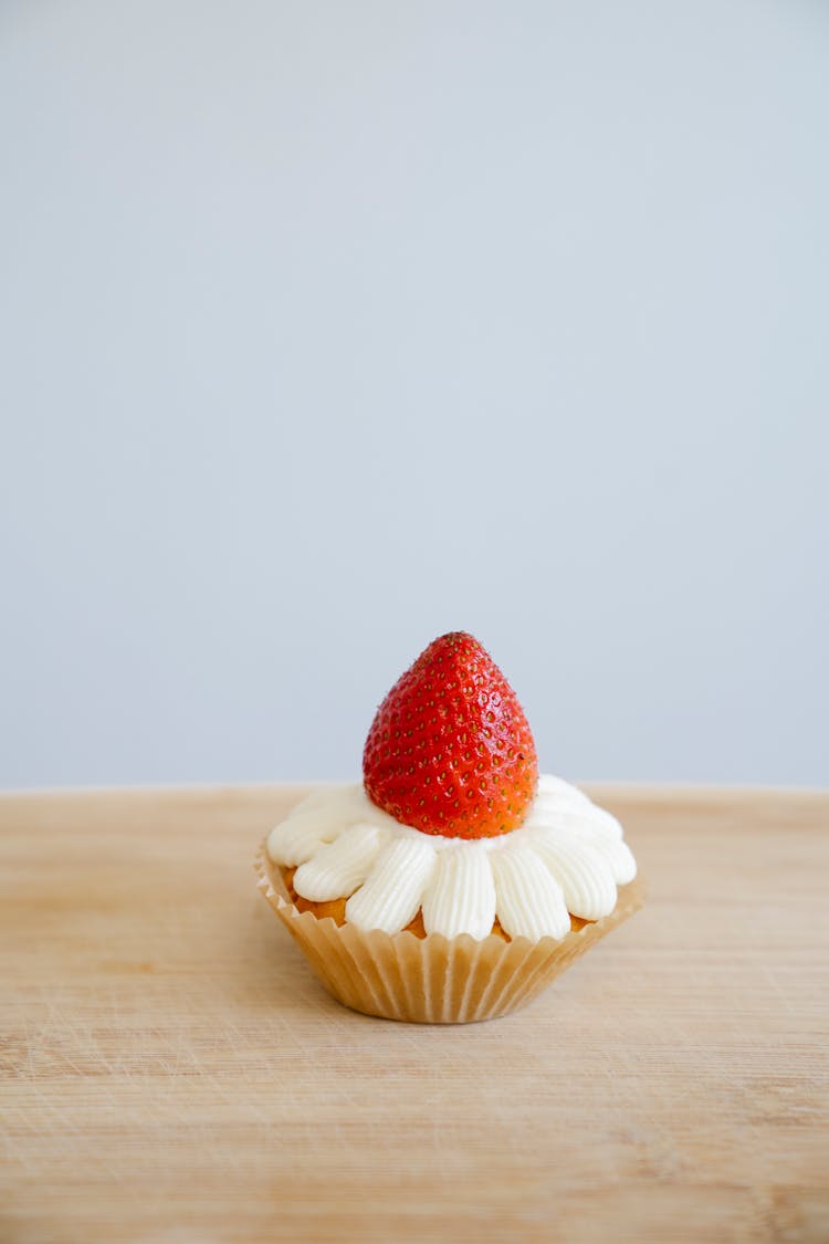 Close-Up Shot Of A Cupcake With Strawberry