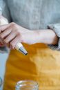 Person Holding Pen and Writing on Paper