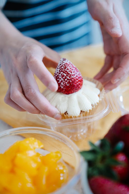 Free Close-Up Shot of a Person Holding a Cupcake Stock Photo