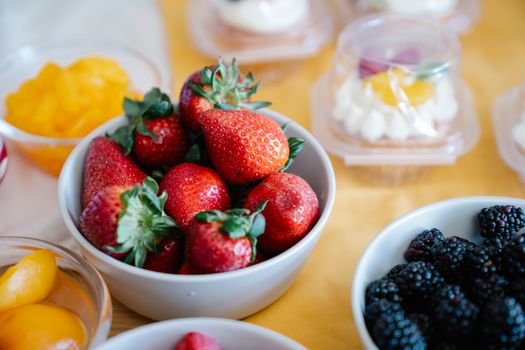 Close-up of bowls filled with fresh strawberries and berries, ideal for healthy eating concepts.