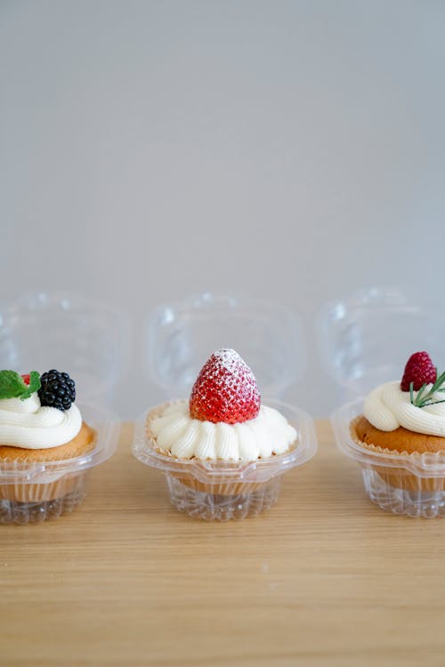 Cupcakes with Icing and Fruits Toppings