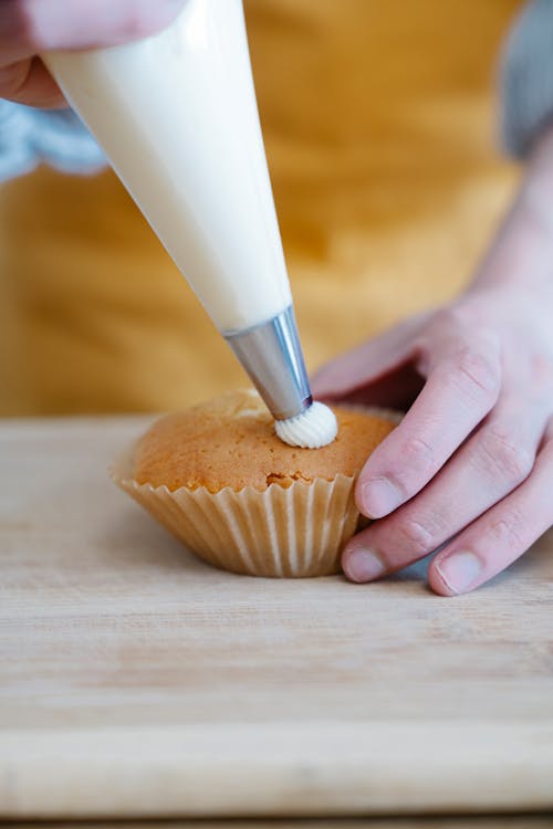 Hands Decorating Cupcake