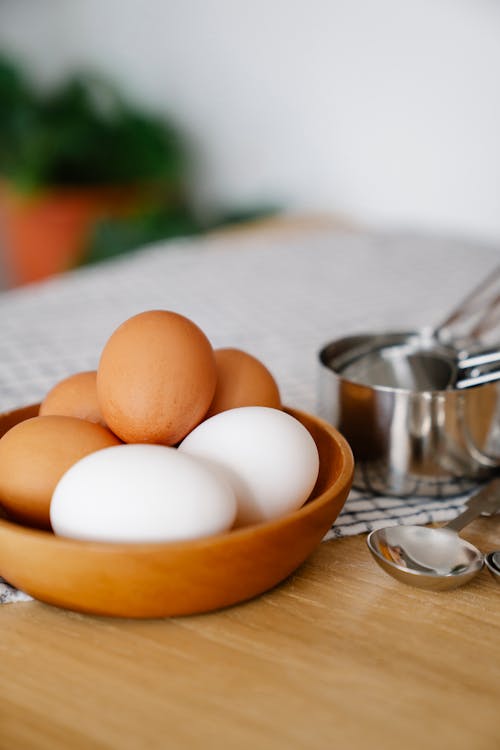 Brown and White Eggs on the Wooden Bowl