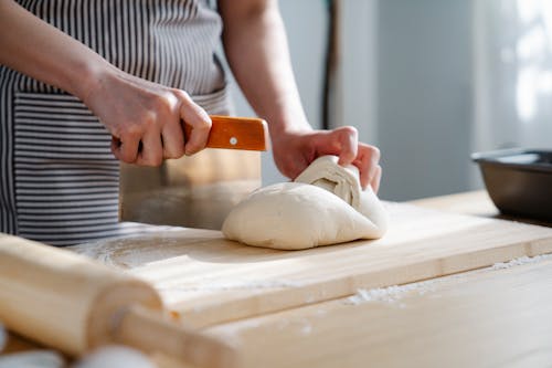 Free Baker Cutting a Dough Stock Photo