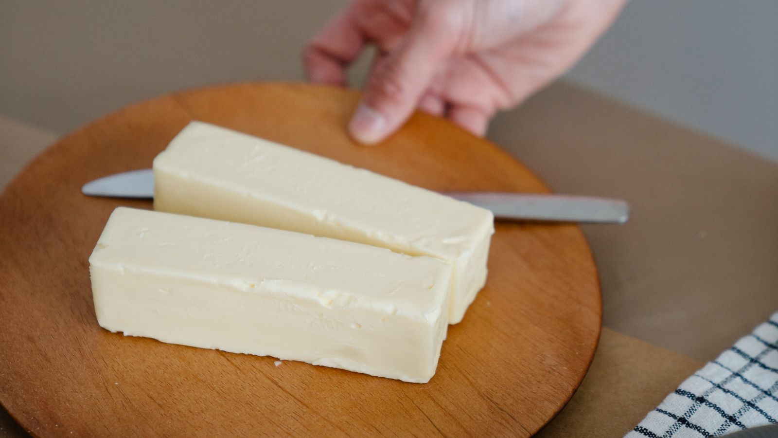 Two blocks of butter on a wooden plate — photo by Felicity Tai on Pexels Two blocks of butter on a wooden plate