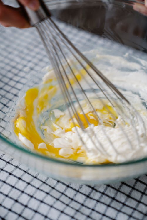 Person Holding Stainless Whisk