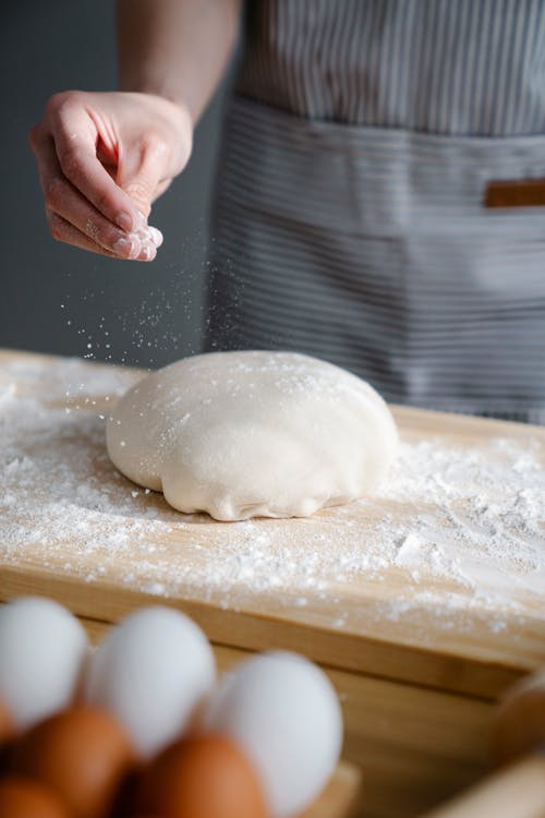 Free Person Putting Flour on a Dough Stock Photo