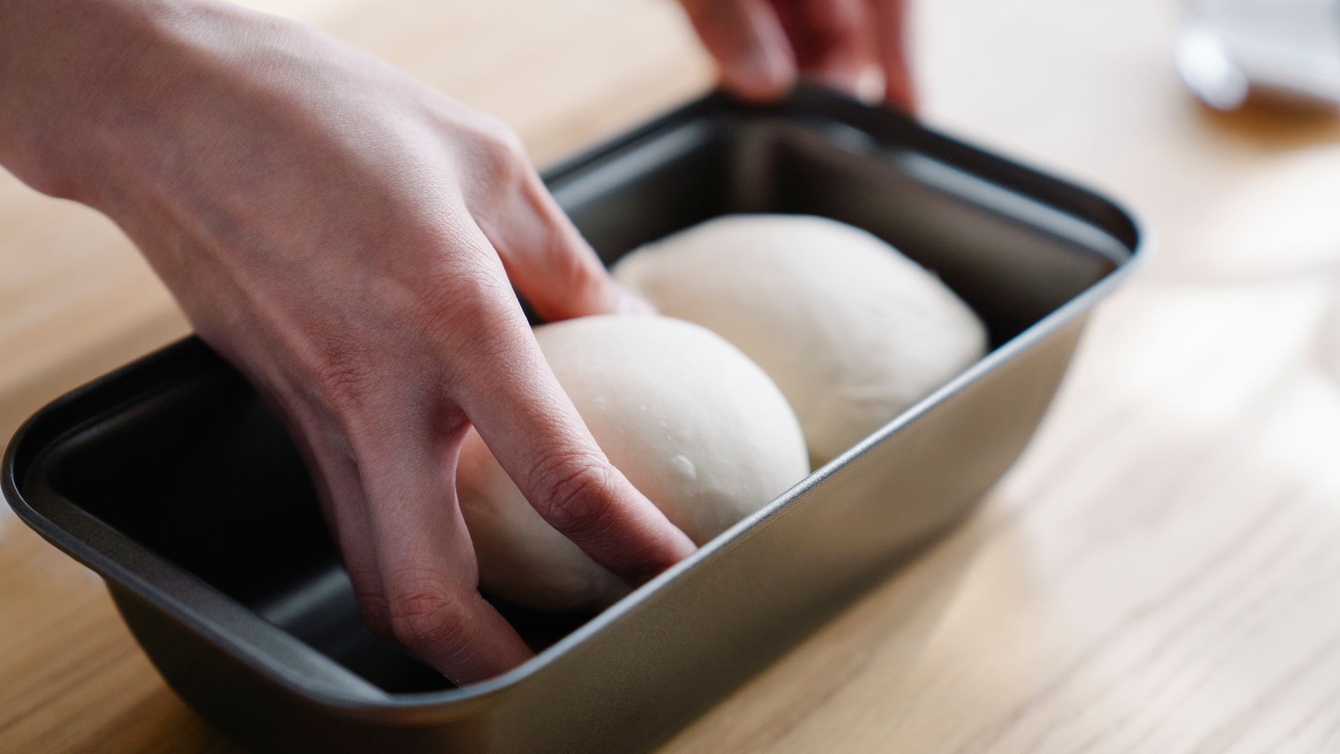 How Does Modafinil Work: Unlocking the Brain's Potential Close-up of hands placing dough balls in a tray, ready for baking — how does modafinil work