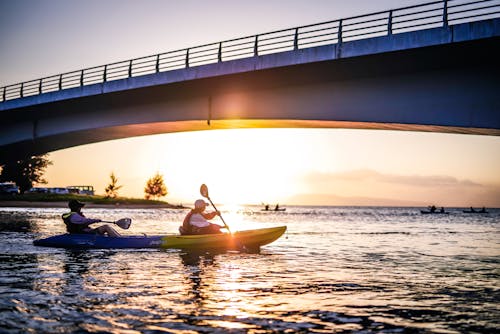 Kayakers Under a Bridge