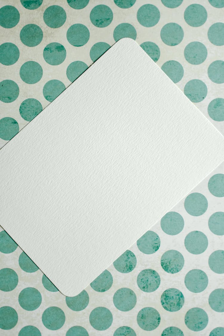 A Blank Card On A Polka Dot Surface