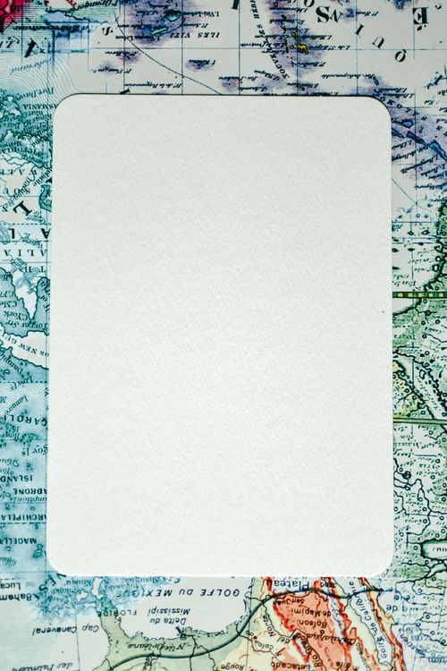 White Paper Sheet Lying on a Geographical Map · Free Stock Photo