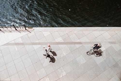 Overhead Shot of a Person Riding a Bike Near People