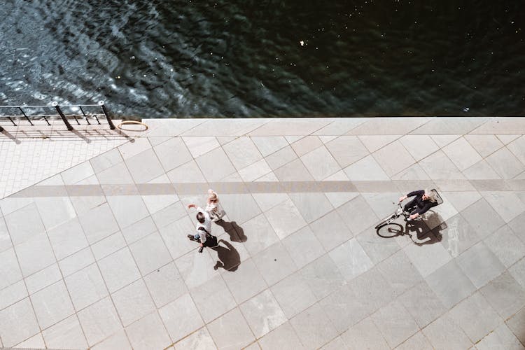 Overhead Shot Of A Person Riding A Bike Near People