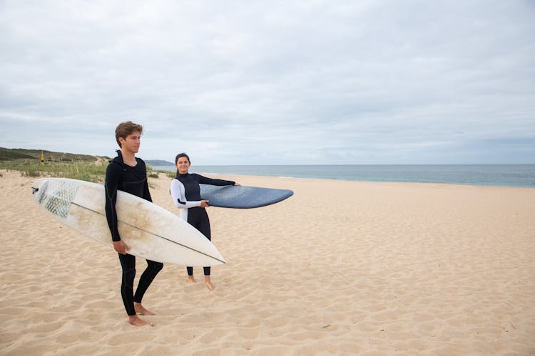 Photo Of Surfers Walking On The Sand